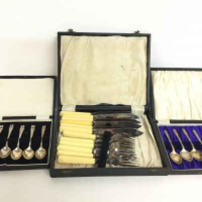A collection of silver plated cutlery including one set of silver hallmarked spoons.
