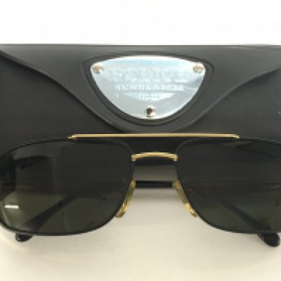 A cased pair of Police MOD 2345 sunglasses, postage category A
