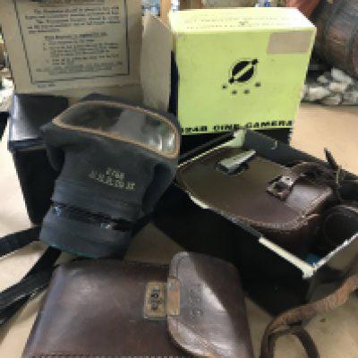 A WWII respirator in original box, a Bell & Howell - Cine Camera with instruction with instruction leaflets and wide angle attachments. In original box and leather case, together with an IHAGEE- German Camera-105/4.5 lens in original leather case. NO RESERVE