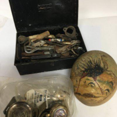 A collection of bottle openers corkscrews an old painted ostrich egg and a tub containing oddments including a trench art lighter. NO RESERVE
