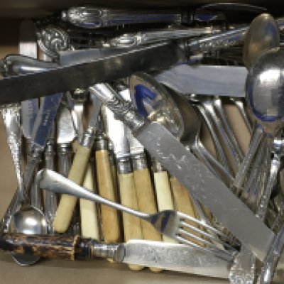 A collection of cutlery including spoons, knives, forks . Postage cat C