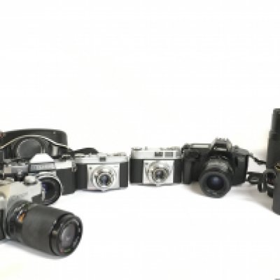 A collection of various vintage cameras including a Canon TX, Praktica Nova, Kodak Retinette, Canon EOS 650 and lenses including a Sanko Kohki 200mm, Panagor E 300mm, Paragon 135mm. This lot cannot be posted