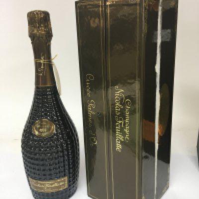 A bottle of Champagne Nicolas Feuillatte 1996 champagne. In a fitted presentation box