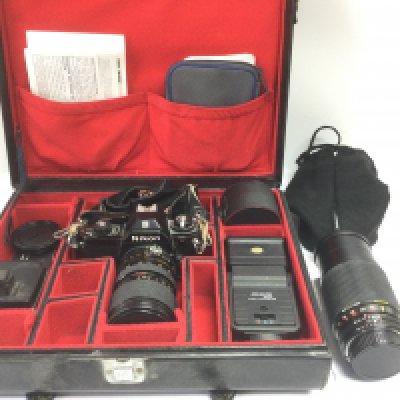 A cased Nikon camera, lens and accessories plus a further Zoom lens (2). Shipping category D.