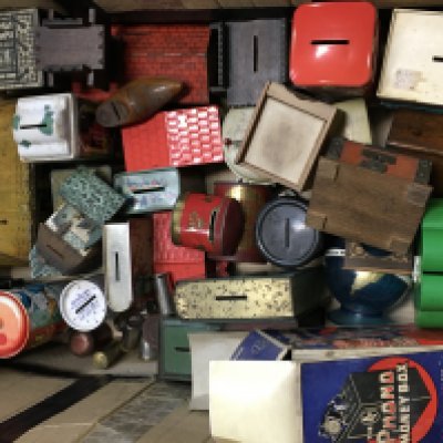 A collection of vintage money boxes including a boxed Phono money box mostly tin plate examples