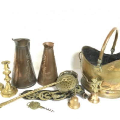 A collection of copper jugs, a coal bucket and other brass items. This lot cannot be posted