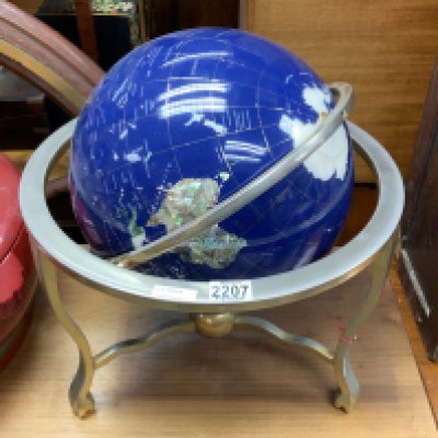 A modern terrestrial globe inlaid with semiprecious stones etc