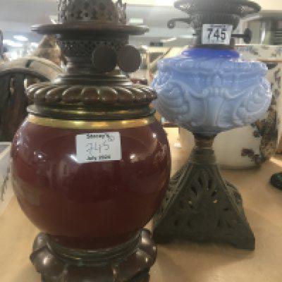 Two oil lamps with cast iron bases, ceramic and glass fonts. NO RESERVE.