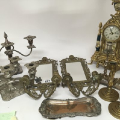 A pair of brass Girondelle a collection of candle sticks and candelabra a French style clock and a silver plated tray.