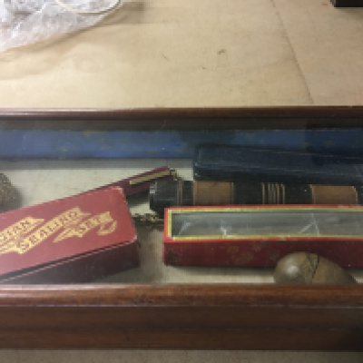 A small mahogany flat top display cabinet containing objects of Du vertical 44 cm x 20 cm .