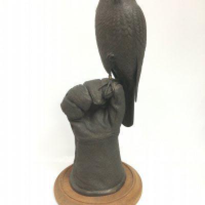A Dennis Taplin sculpture of a bird of prey, approx total height 48cm. Shipping category D.