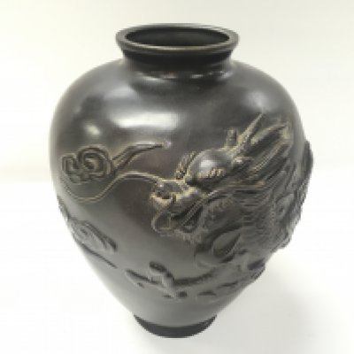 A Japanese early 20th century bronze vase featuring a raised dragon. Approximately 23cm high and 19cm wide.
