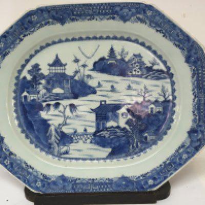 A Very large 18th Century Chinese Export porcelain serving dish with a shaped edge on a wooden stand. 52cm wide x 42cm no obvious damage.