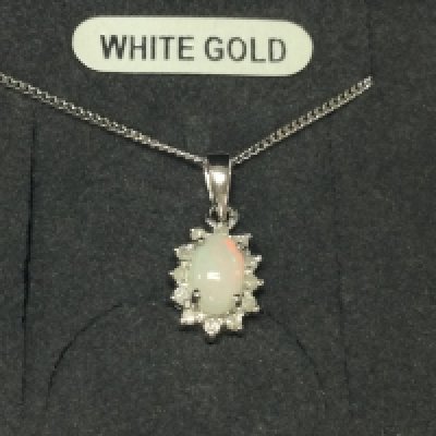 A 9ct white gold chain with attached diamond and opal pendant.