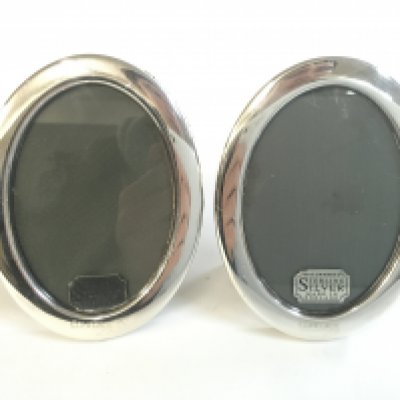 A pair of silver oval Concorde frames . Postage category A