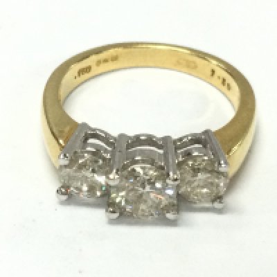 An 18ct gold three stone diamond ring set with approximately 1.5ct total and size M 1/2 and 5.1g