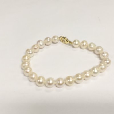 A bracelet strung with white cultured pearls with a gold plated clasp. Shipping category A.