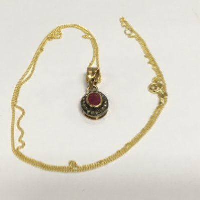 An oval ruby and R/C diamond halo gold plated silver pendant on a gold plated chain. Shipping category A.
