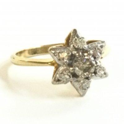 An 18ct gold diamond cluster star ring , size Q. 4g total weight. Postage category A