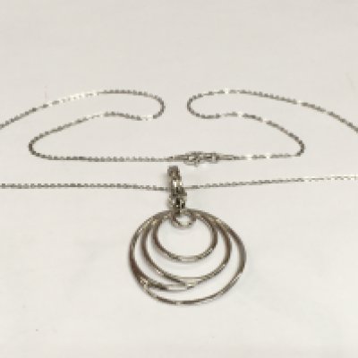 A circular modern art inspired silver pendant suspended on a silver chain. Shipping category A.