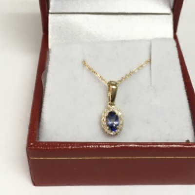 A 9ct yellow gold oval sapphire and RBC diamond cluster pendant on a 9ct yellow gold chain. Sapphire approx 0.31ct, diamonds approx 0.07ct. Approx 1.5g. Shipping category A.