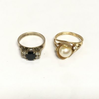 Two unmarked yellow metal stone set rings, approx total weight 7.6g. Shipping category A.