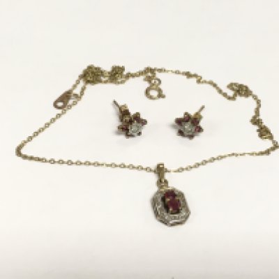 A 9ct gold diamond and garnet pendant on a gold chain and a matching pair of earrings. Approx total weight 3.4g. Shipping category A.