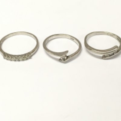 Three platinum diamond rings of various designs. Sizes J M P approximately 8g