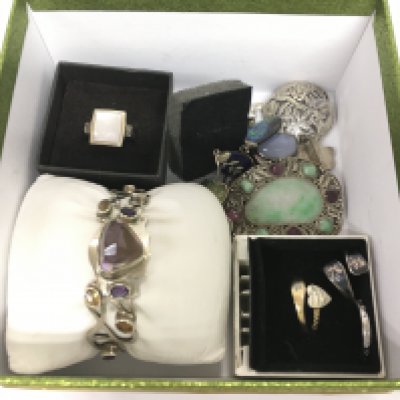 A small collection of silver jewellery items comprising a bangle, rings, brooches etc. Shipping category B.