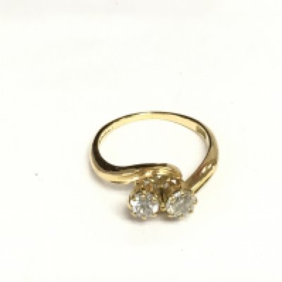 An 18ct gold two stone diamond twist ring, approx 3g and approx size K. Shipping category A.
