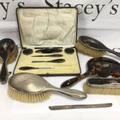 A silver and tortoiseshell dressing table set. Shipping category D.