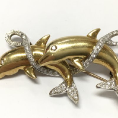 An unmarked gold dolphin brooch set with diamond stones , 14.5g total weight. Postage category A