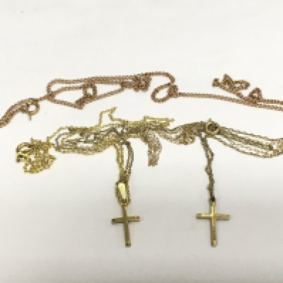 Three gold chains and two cross pendants, approx total weight 7g. Shipping category A.