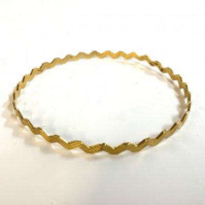 A 9ct gold ZigZag bangle. (A)