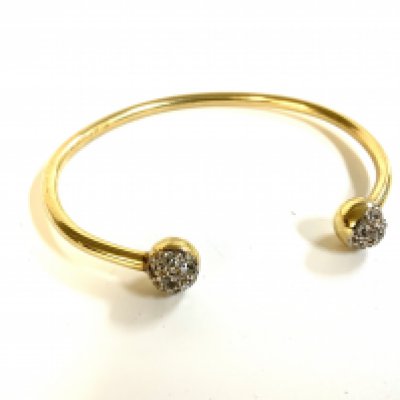 A 9ct gold and white stone set Tourqe bangle . 6cm x 5cm. (A)
