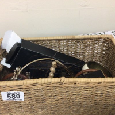 A basket containing a collection of costume jewellery and other oddments.