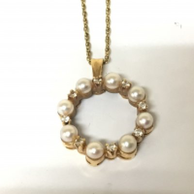 An 18carat gold pendent set with pearls and alternating diamonds. With attached 18carat gold chain. Total weight 8.5g