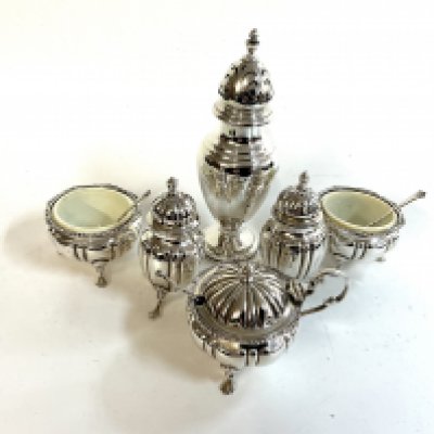 A small hallmarked silver sugar caster together with a 5 piece hallmarked silver cruet set.