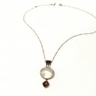 An art deco style necklace with mother of pearl and garnet design . Postage cat a