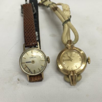 Two vintage ladies gold omega watches.