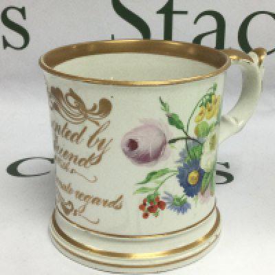 A large late 19th Century ceramic mug decirated with floral sprays and script with applied frogs and lizard to interior, approx height 11cm. Shipping category D.