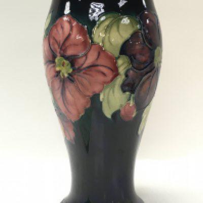 A Moorcroft Anemone vase, some damage at the bottom of the vase. this lot cannot be posted