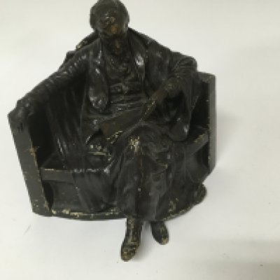 A goldscheider figure in the form of a Gentleman seated . 26 cm .