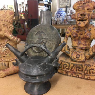 A collection of Mexican pottery including figures and vases .