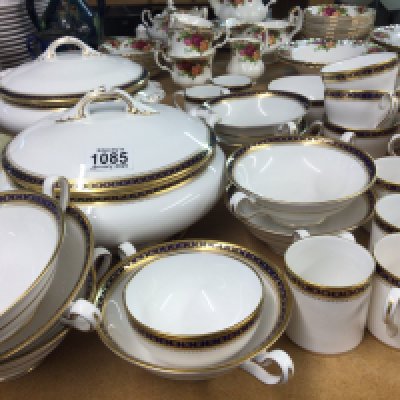 A Spode porcelain dinner service with coffee cups tea cups tureens plates all with a blue and gilded edge no obvious damage.