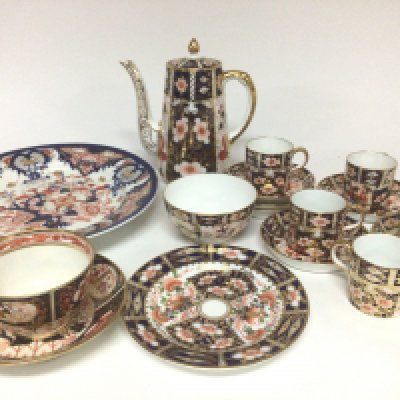 A Royal Crown Derby Porcelain coffee set with coffee pot one cup cracked and other conforming ceramics.