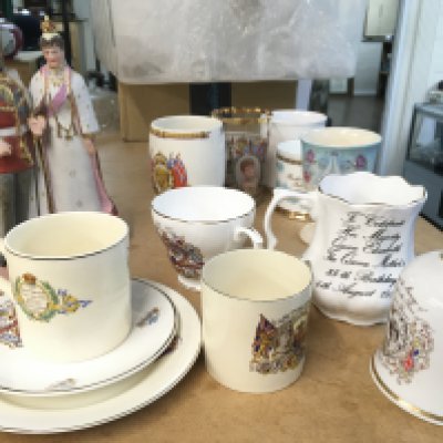 A collection of coronation ware including cups, saucers and a figure group of George V & Mary of Teck. This lot cannot be posted