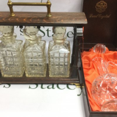 An oak three bottle tantalus and a boxed Webb crystal glass decanter (2). Shipping category D.