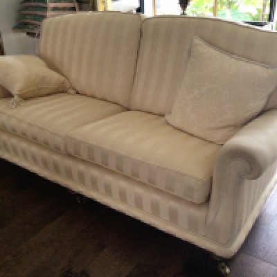 A Fine quality three seater sofa tastefully upholstered in yellow fabric with matching scatter cushions on fluted Mahogany legs terminating with brass cap and caster. (Sold in situ delivery by appointment)