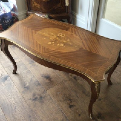 A French Louis XV style coffee table with gilt metal mounts